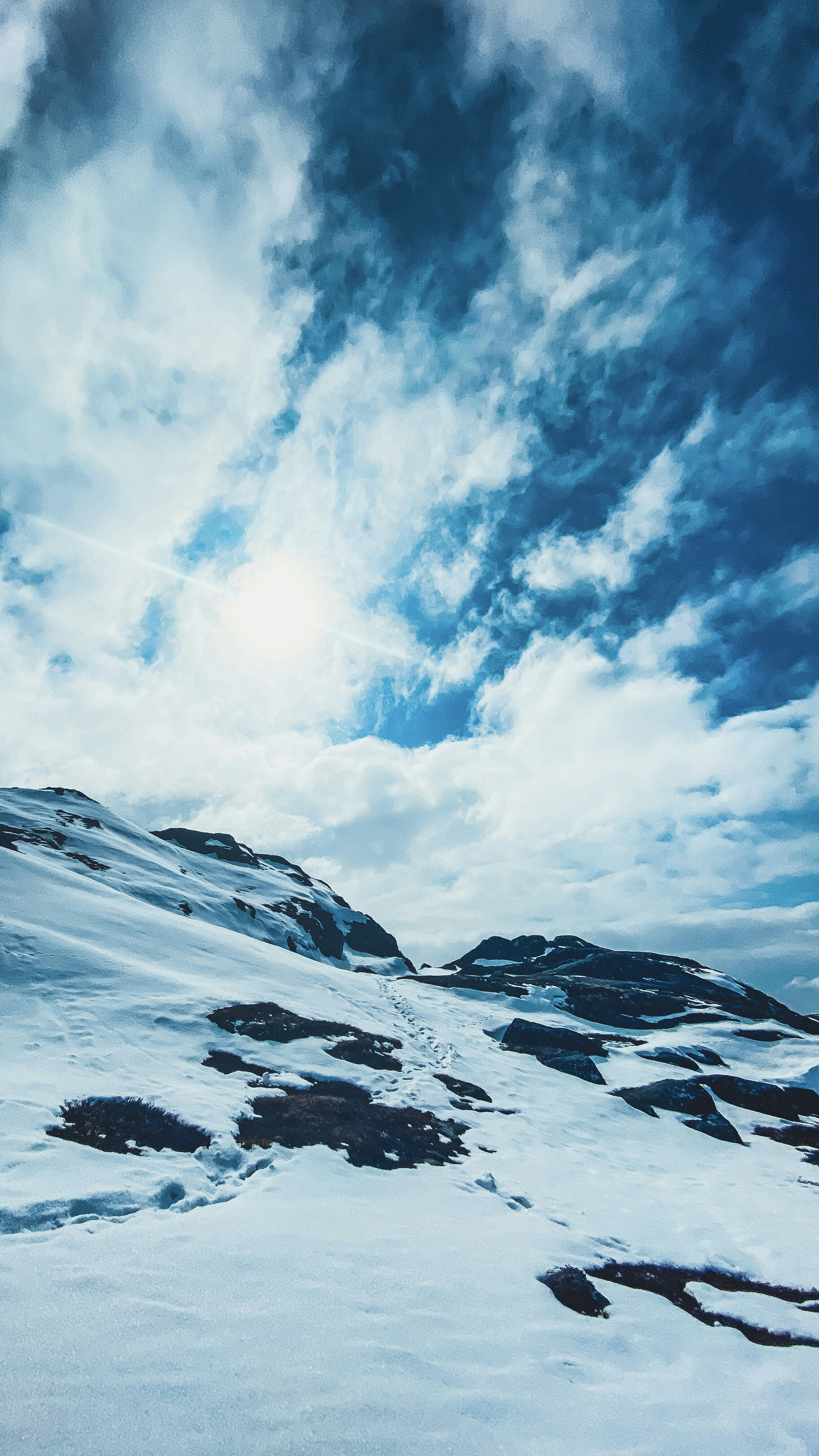 A man riding skis on top of a snow covered slope