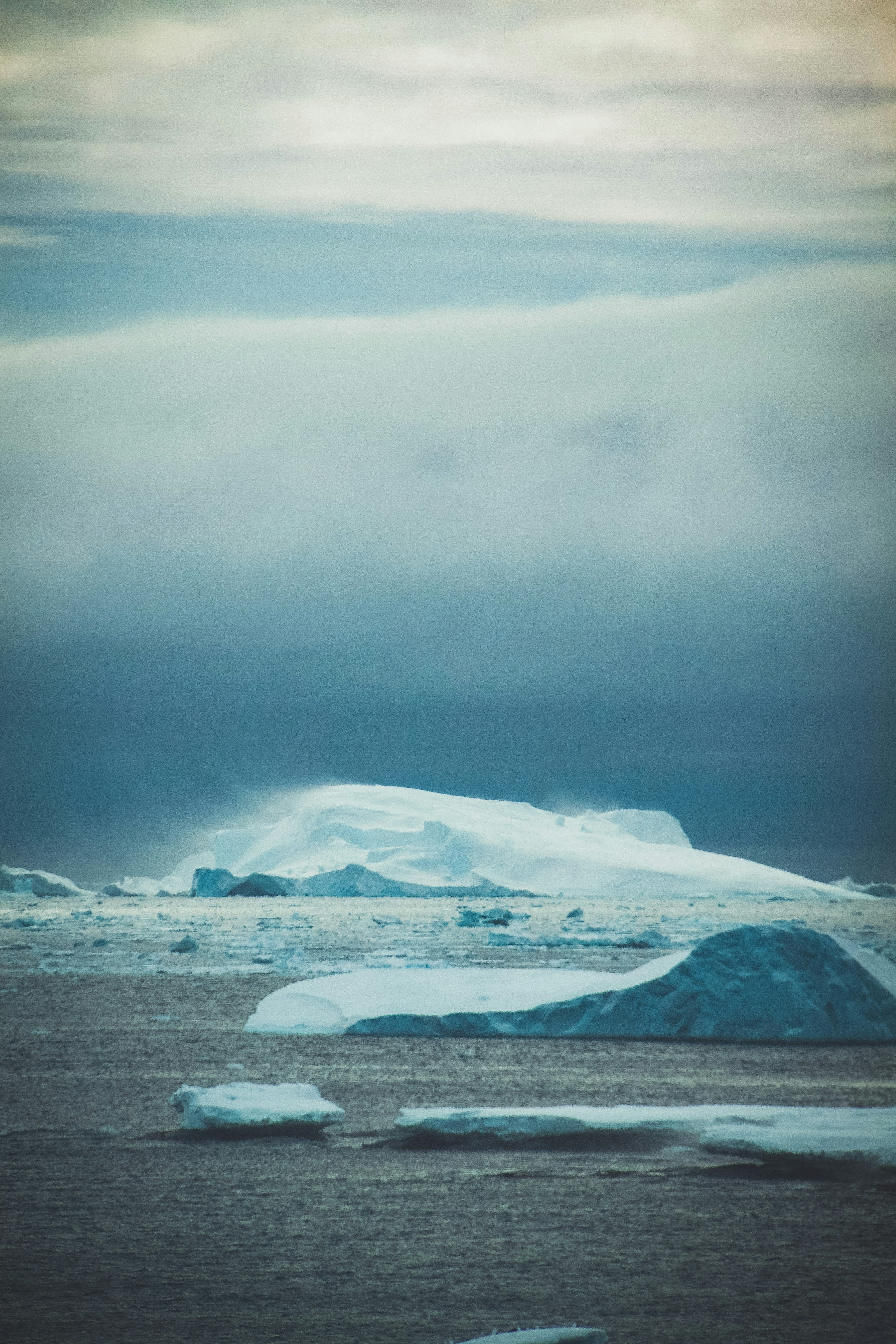 A large iceberg floating on top of a body of water