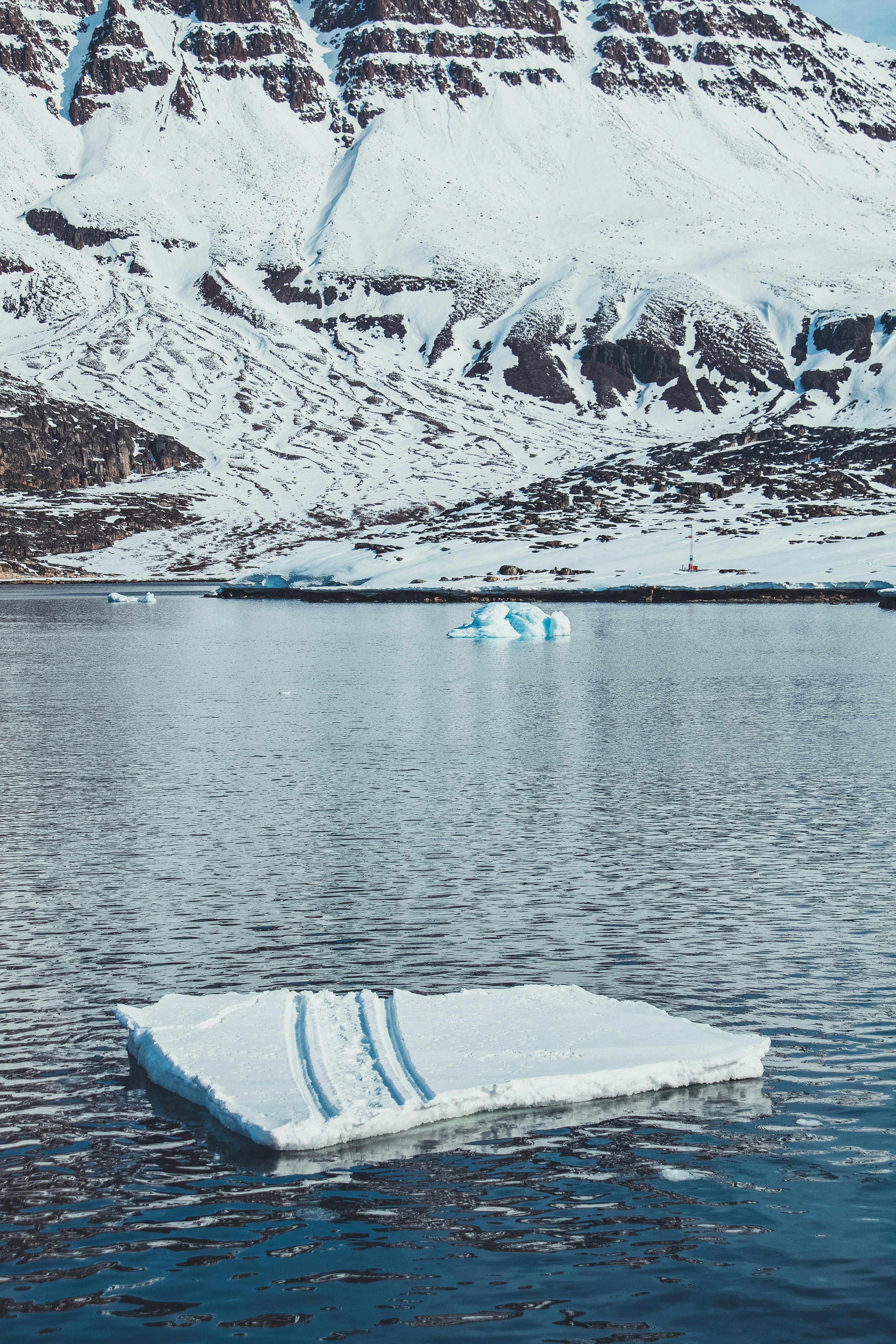 An iceberg floating in the middle of a lake
