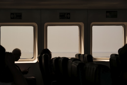 A group of people sitting next to each other on a train