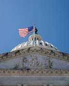 An american flag flying on top of a building