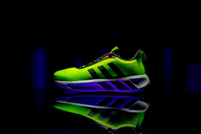 A neon green shoe with a black background