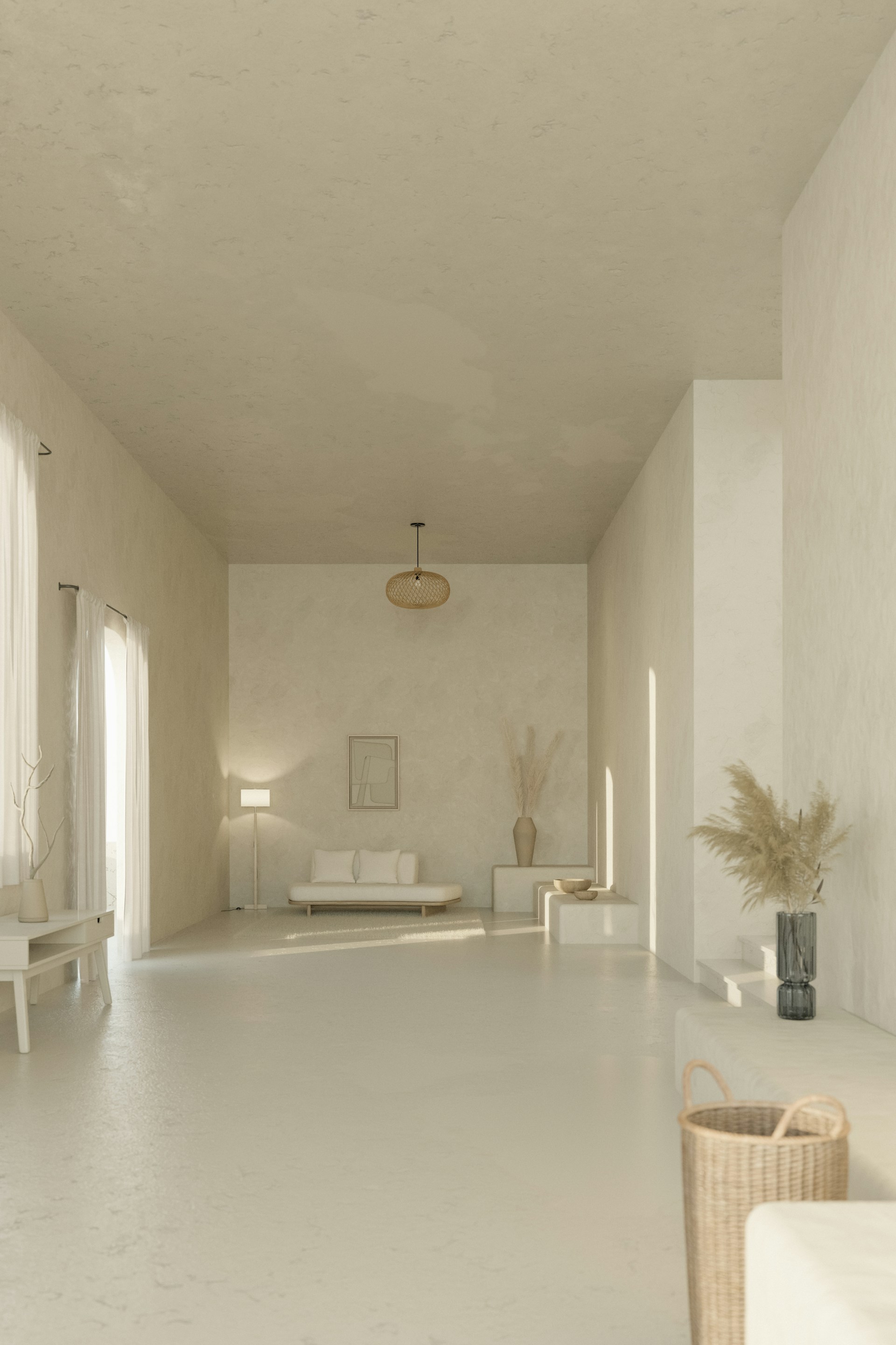 A long white room with a couch and a table