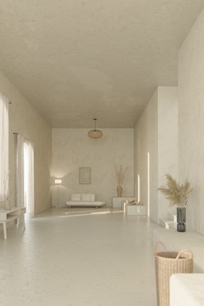 A long white room with a couch and a table