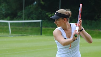 A woman holding a tennis racquet on a tennis court