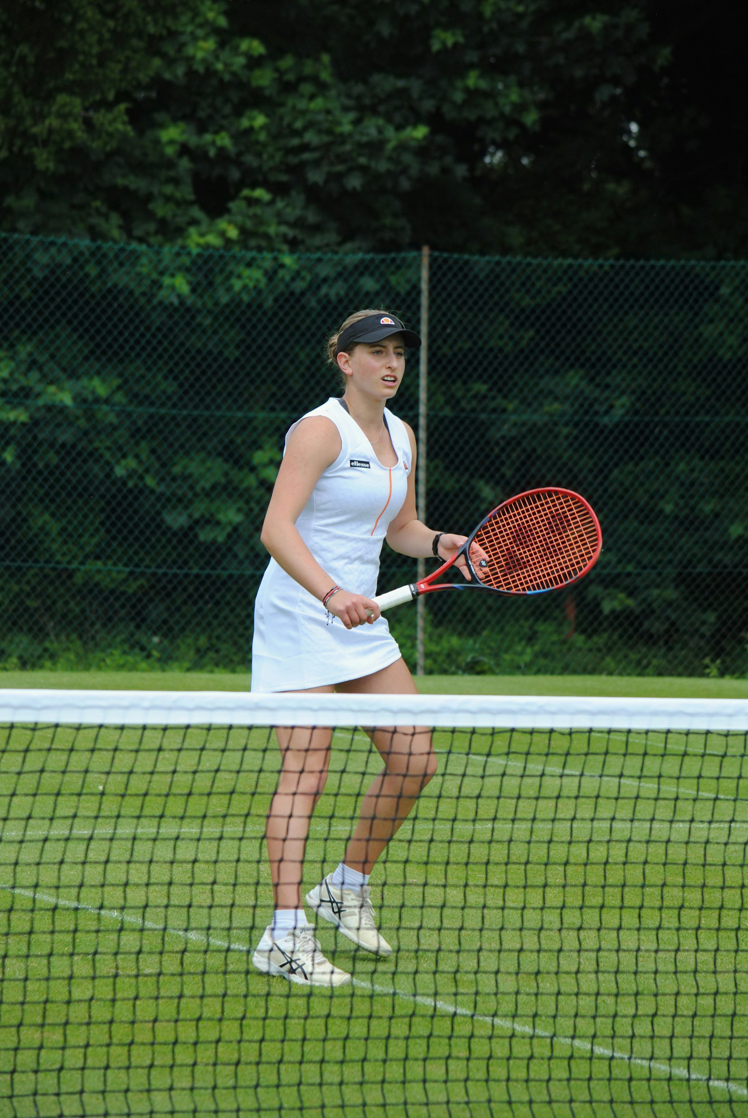 A woman holding a tennis racquet on a tennis court