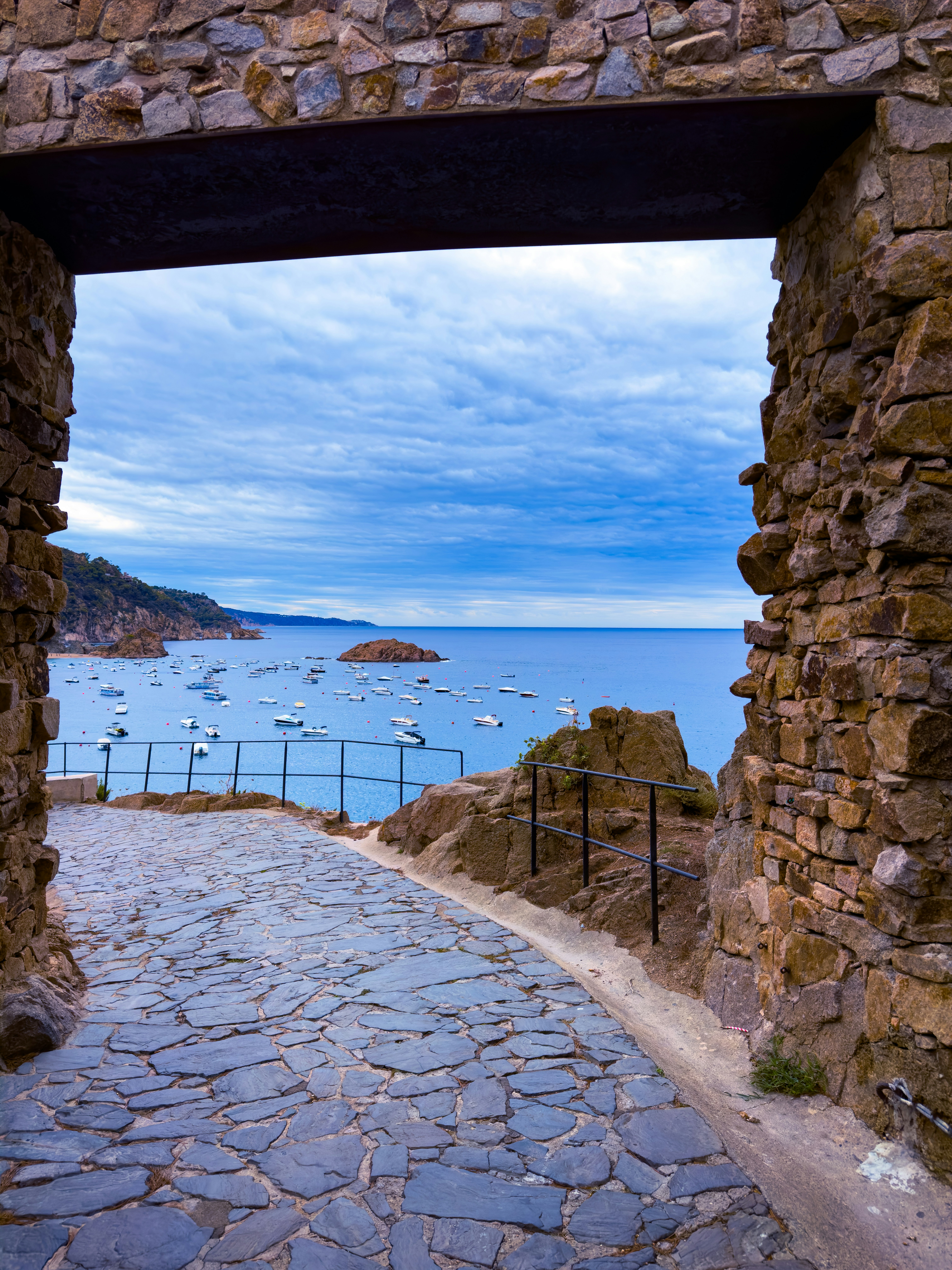 A stone walkway leading to a body of water
