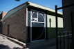 A brick building with a basketball hoop on it