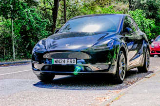 Two cars are parked on the side of the road