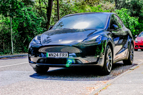 Two cars are parked on the side of the road