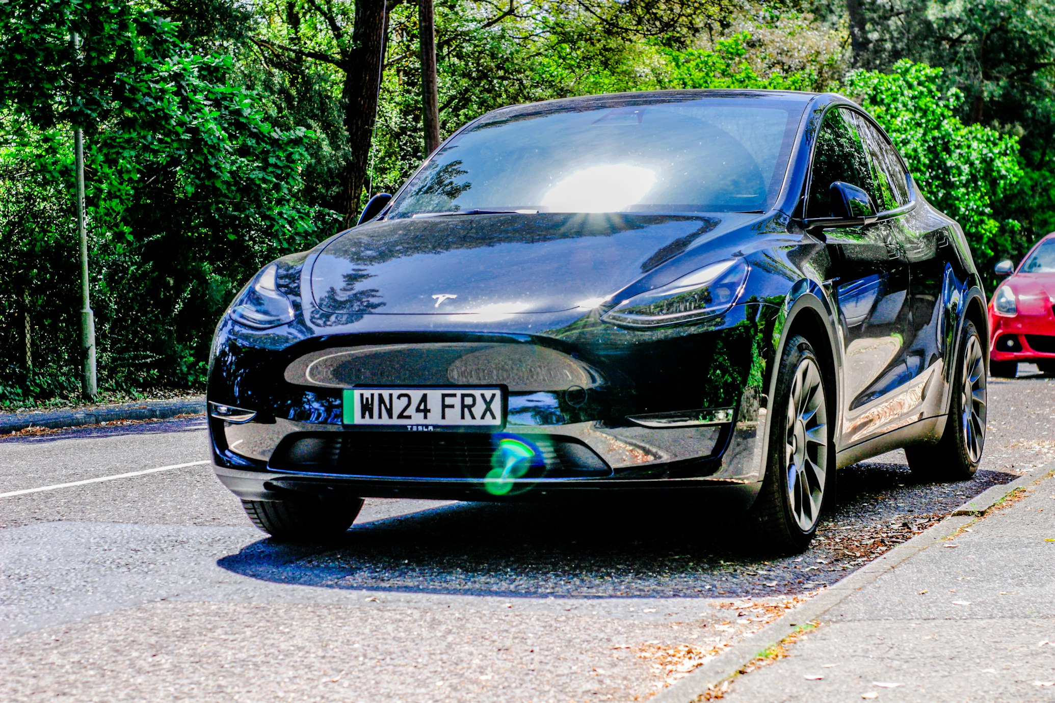 Person examining an electric vehicle at dealership