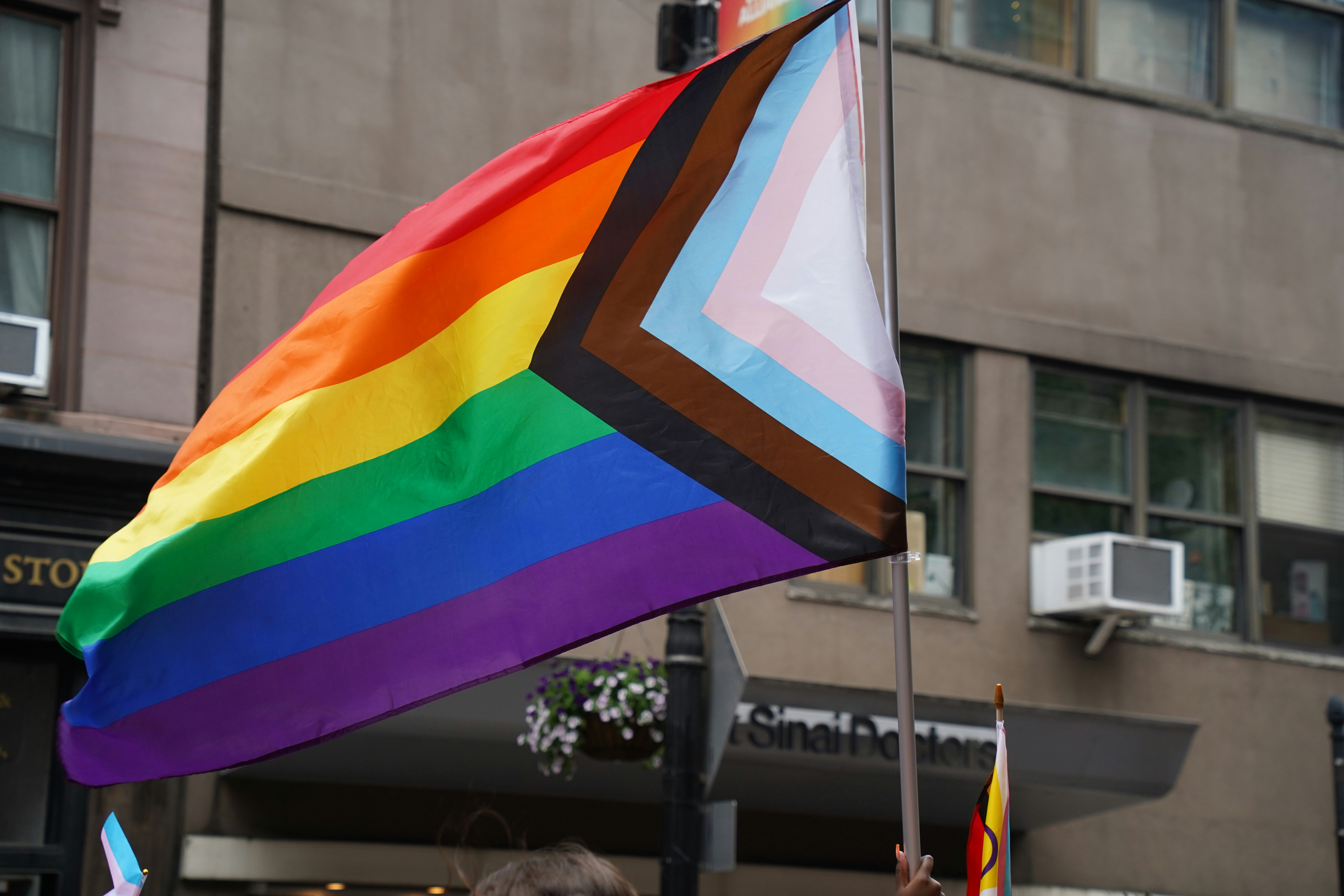 A group of people holding a rainbow flag