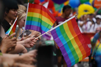 A group of people holding a rainbow flag