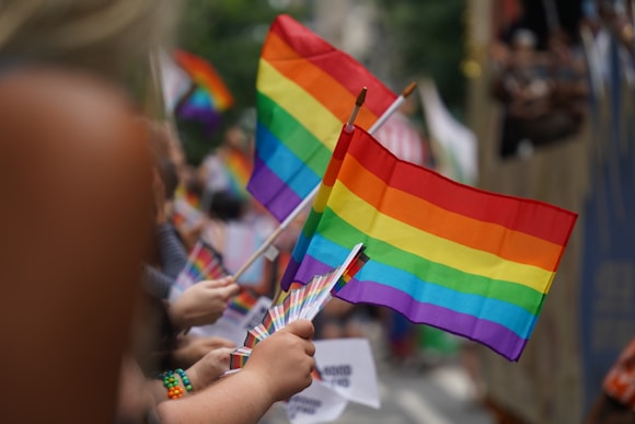 A group of people holding a rainbow flag