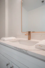A bathroom sink with a large mirror above it