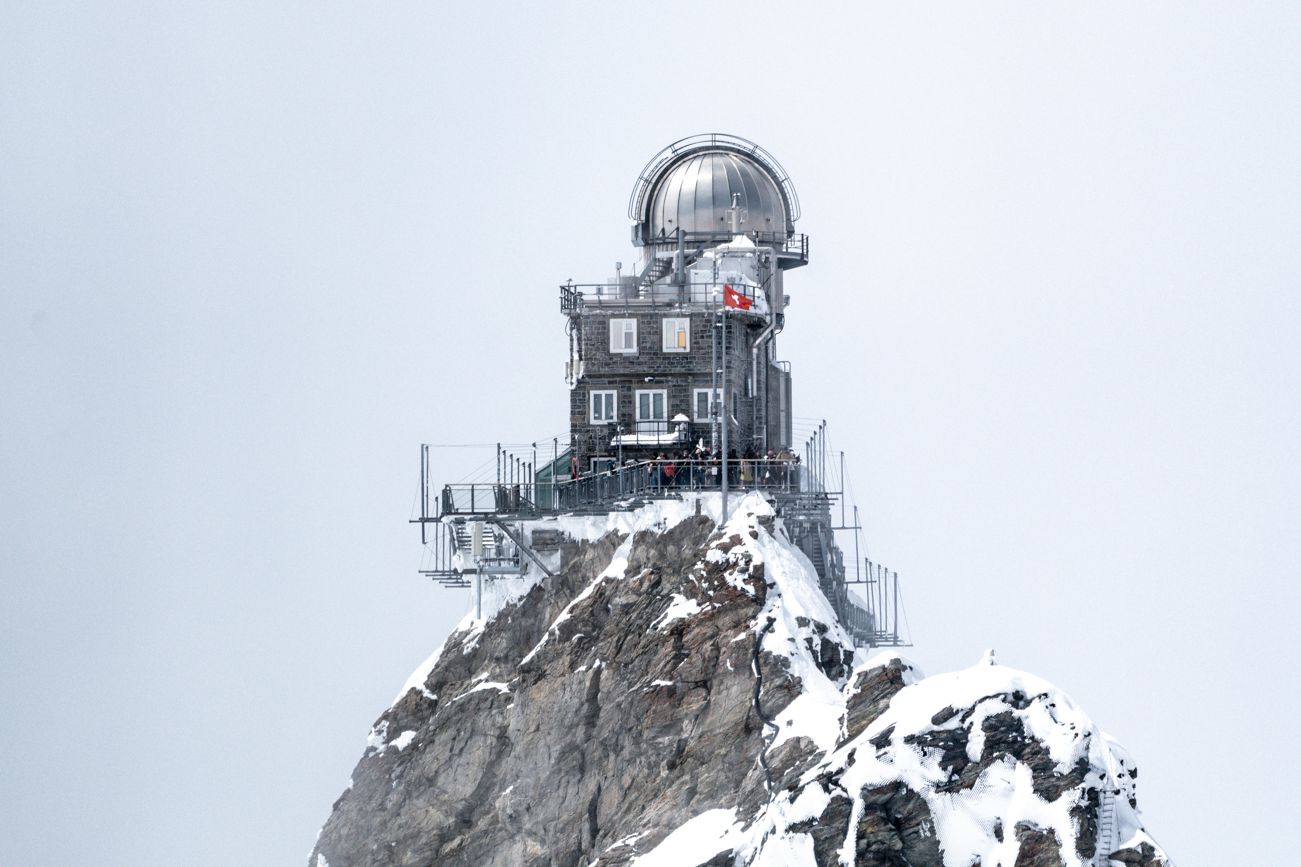 A building on top of a mountain covered in snow, 