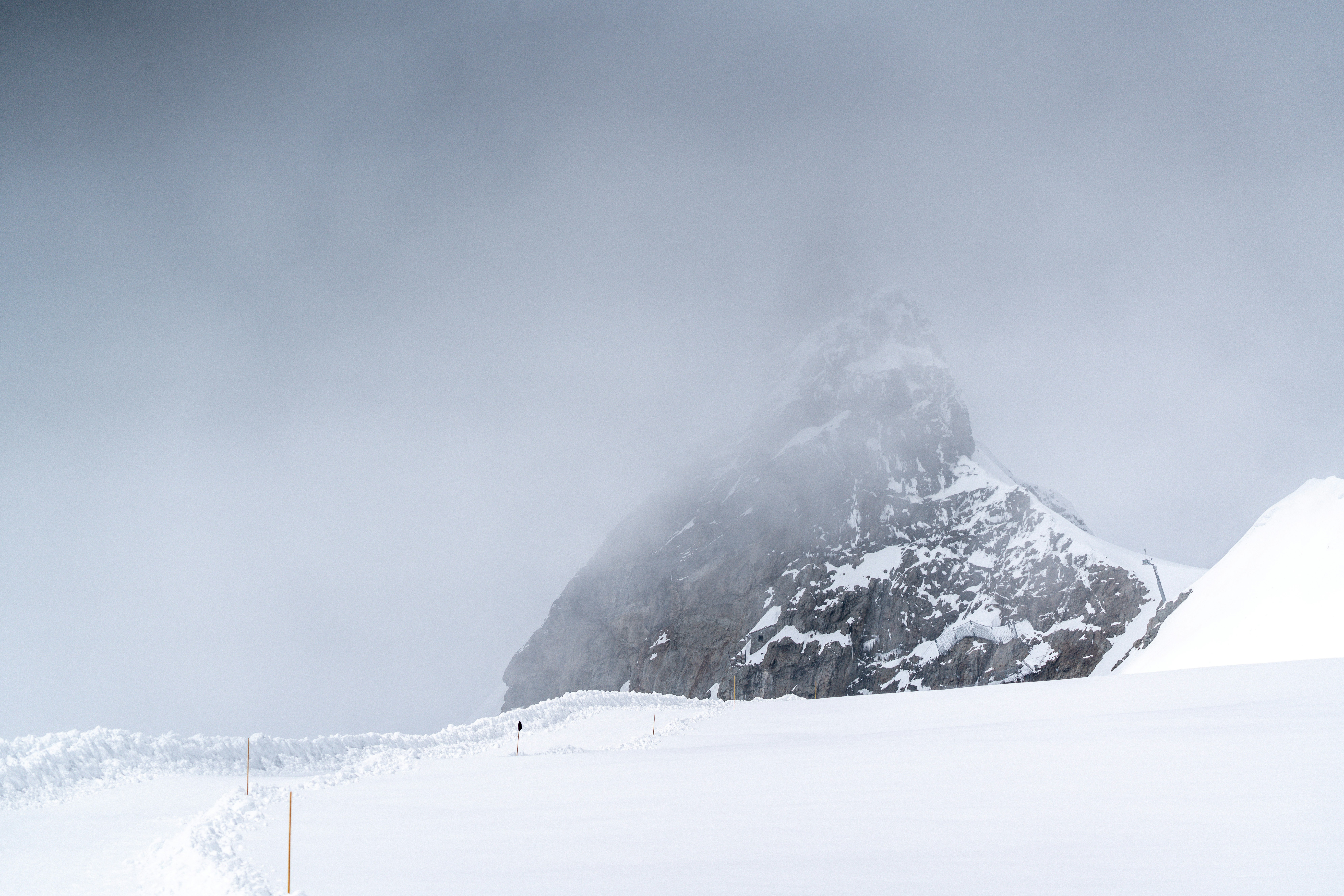 A man riding skis down a snow covered slope