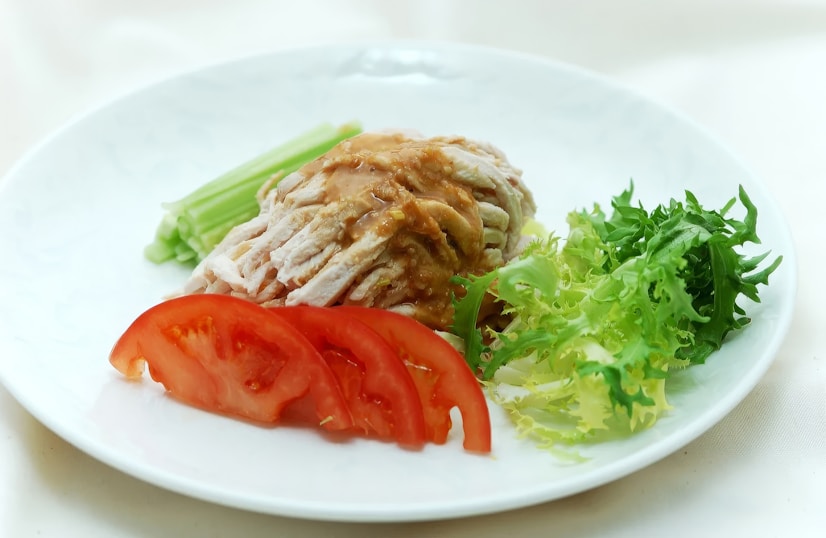 A white plate topped with meat and veggies
