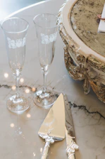 A close up of a table with wine glasses and silverware
