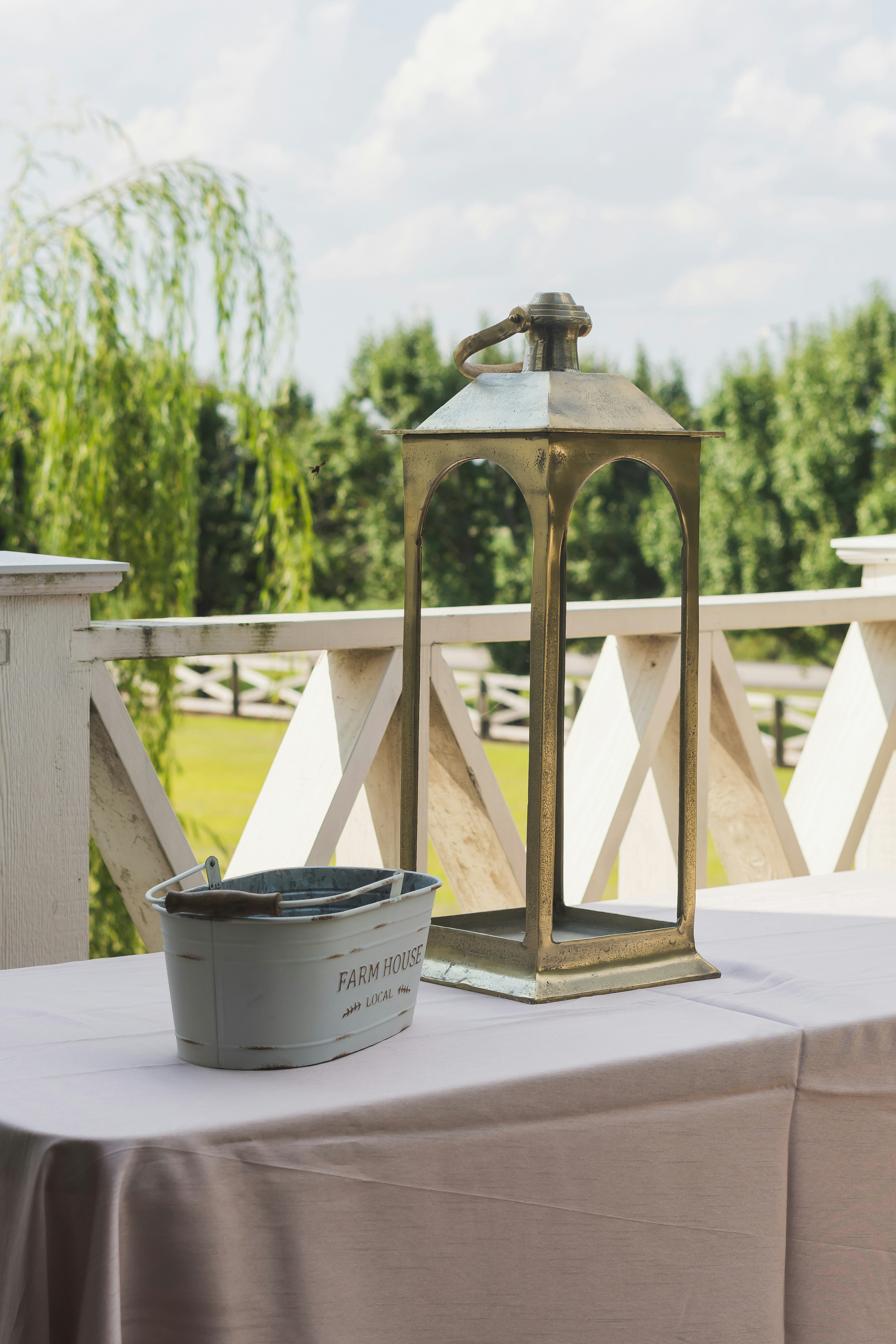 A lantern sitting on top of a table next to a bucket