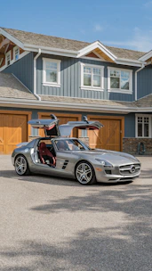 A silver sports car parked in front of a house