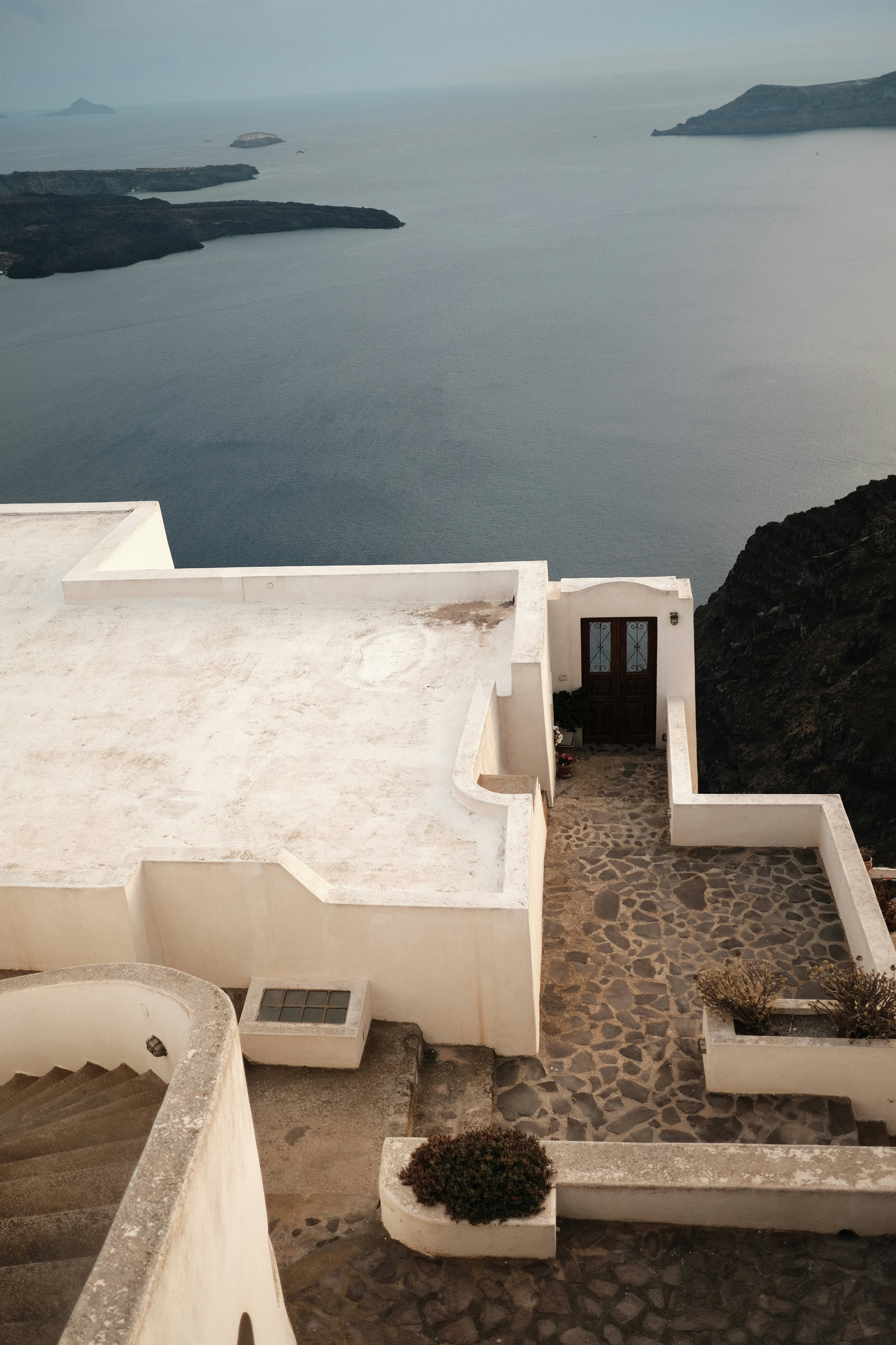 A white building with a large body of water in the background