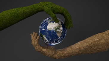 Two hands are holding a small earth globe
