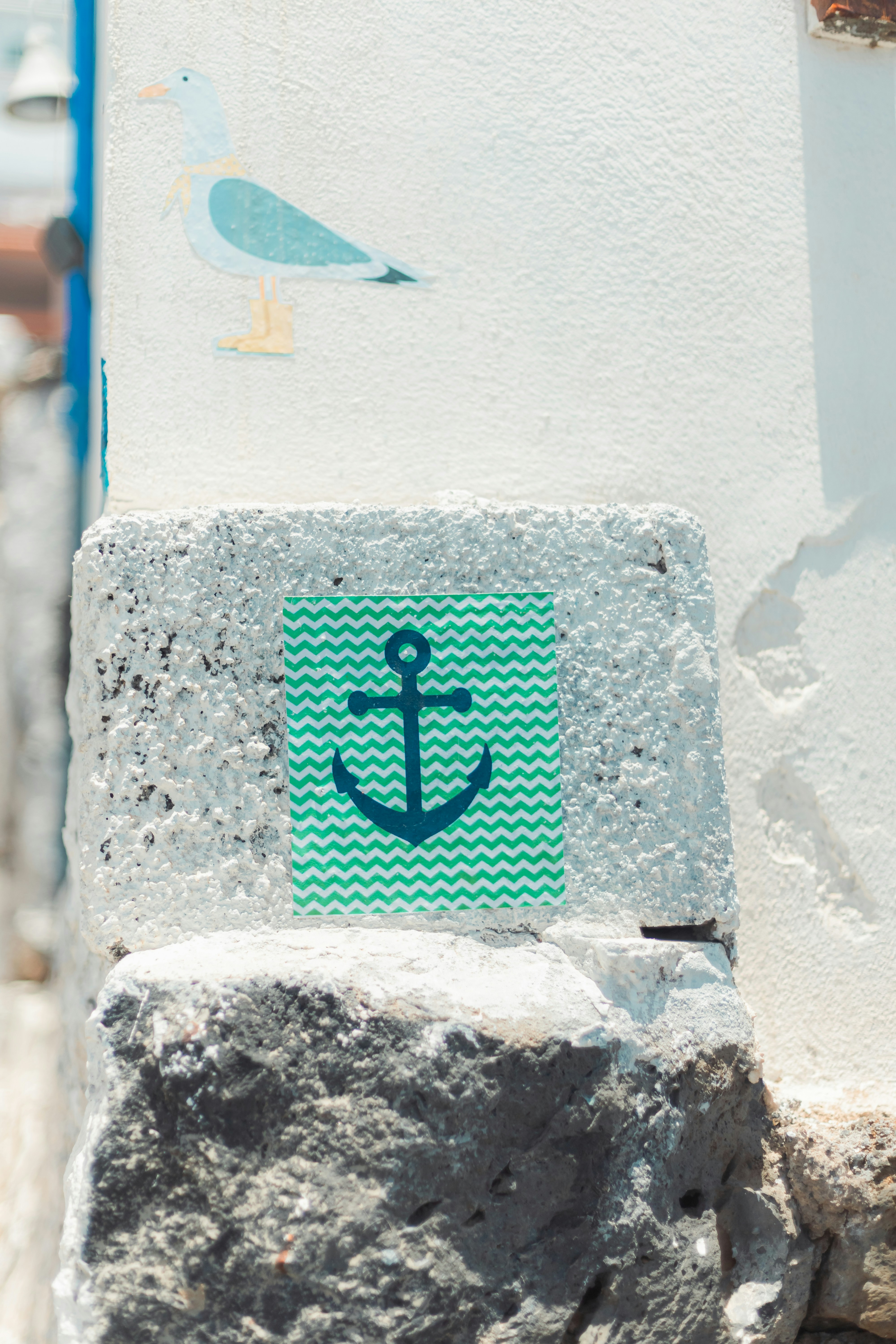 A sticker of an anchor on the side of a building