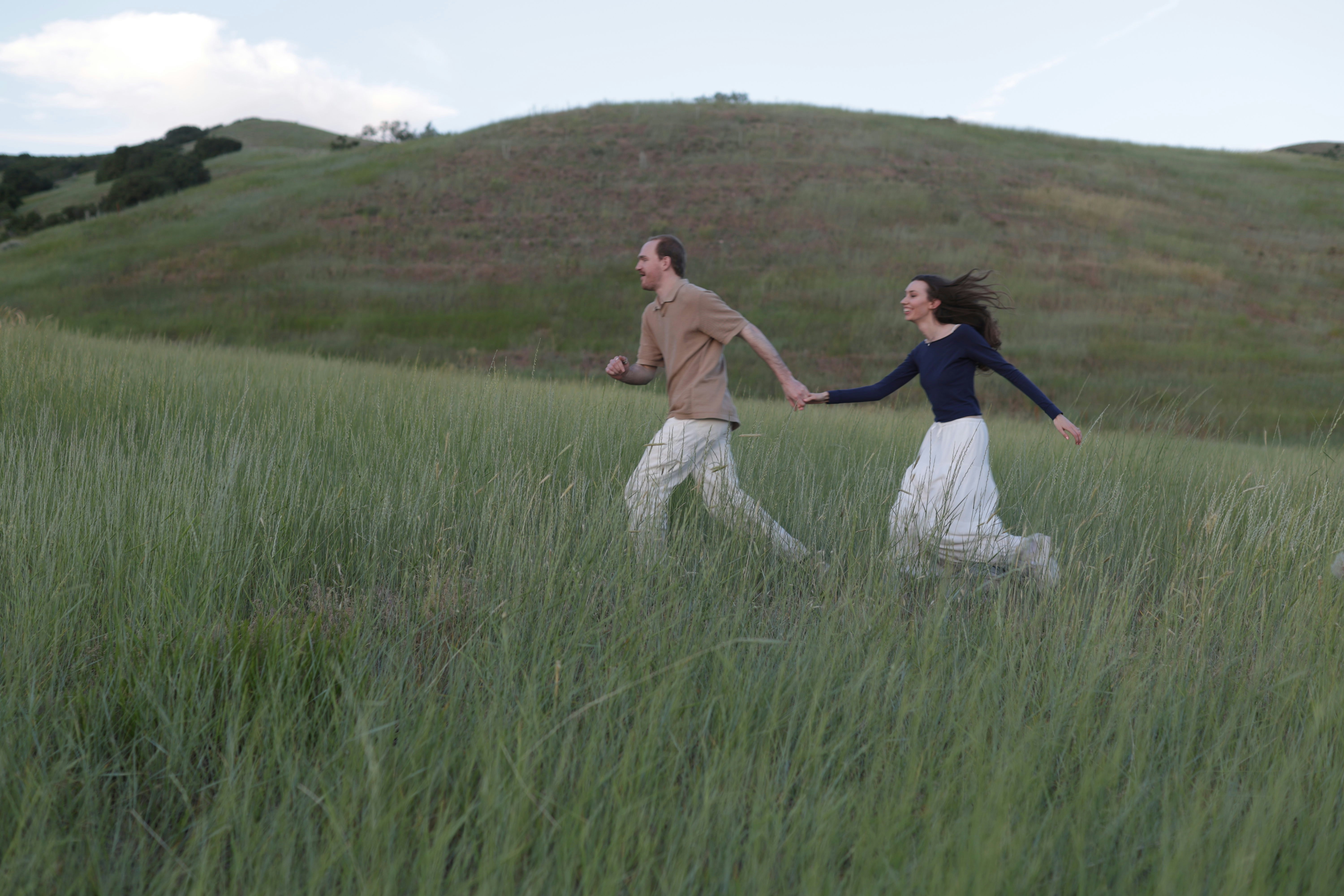 A couple of people that are walking in the grass (Photo by Dallin Thueson on Unsplash)