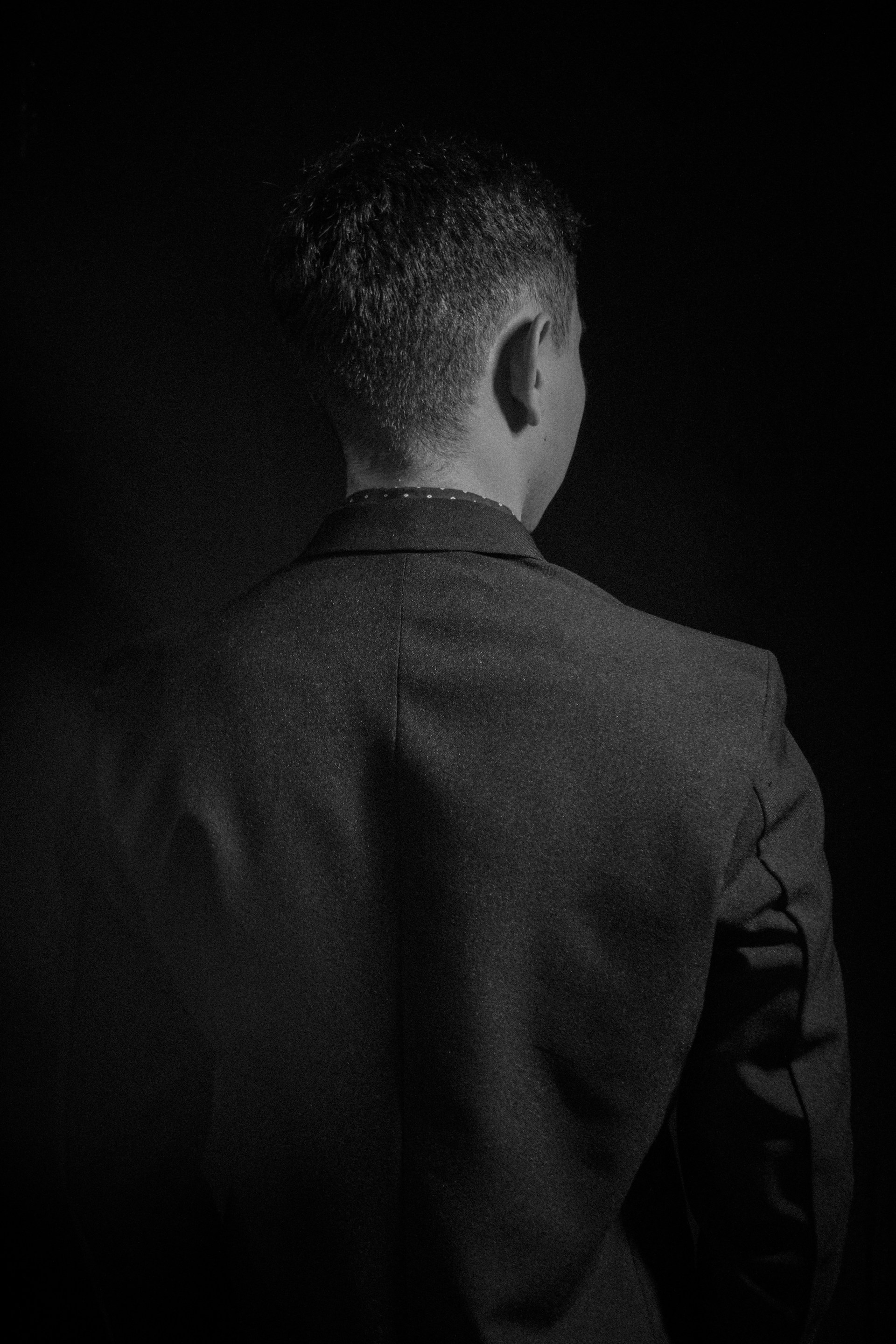 A black and white photo of a man in a suit