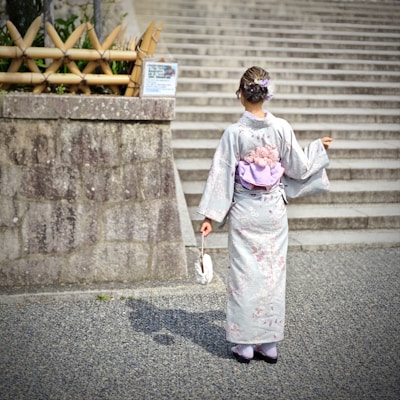 A woman in a kimono walking down the street