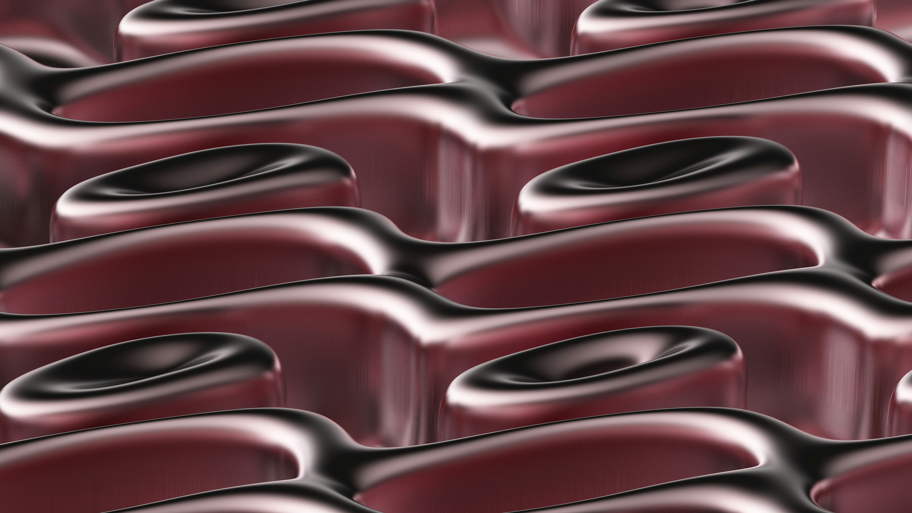 A group of red chairs sitting next to each other