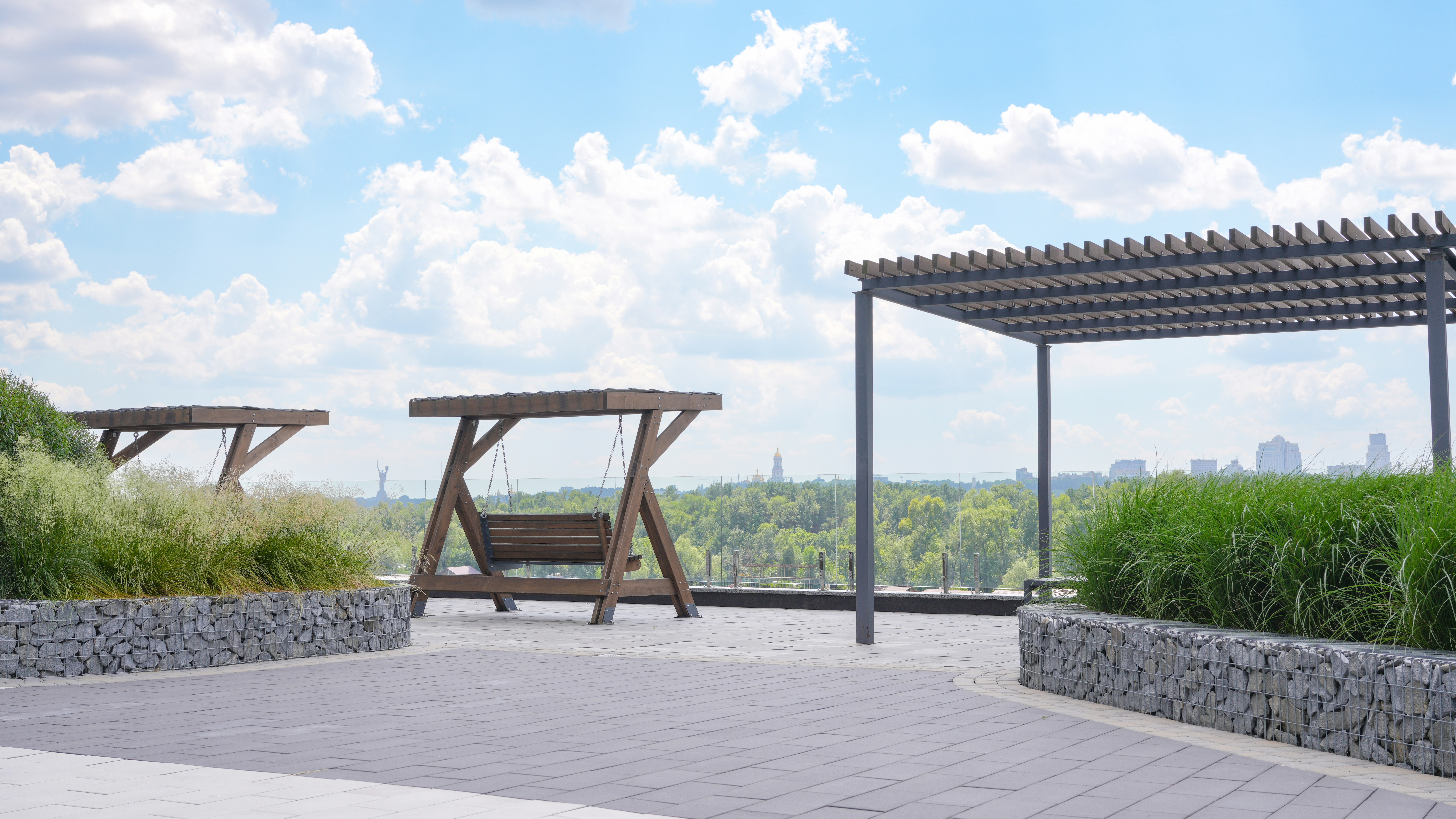 A park bench sitting under a pergolated roof