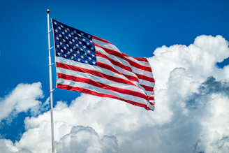 An american flag flying high in the sky
