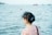 A woman standing on a boat looking at a body of water