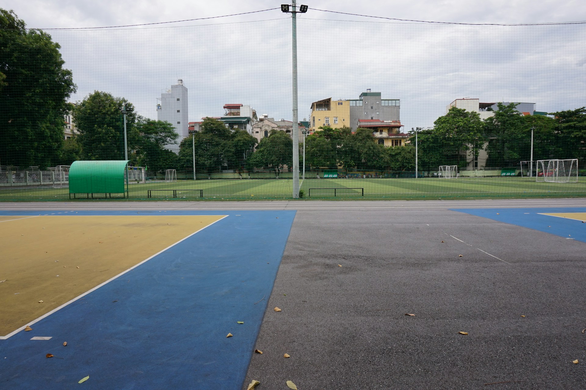An empty basketball court in a city park