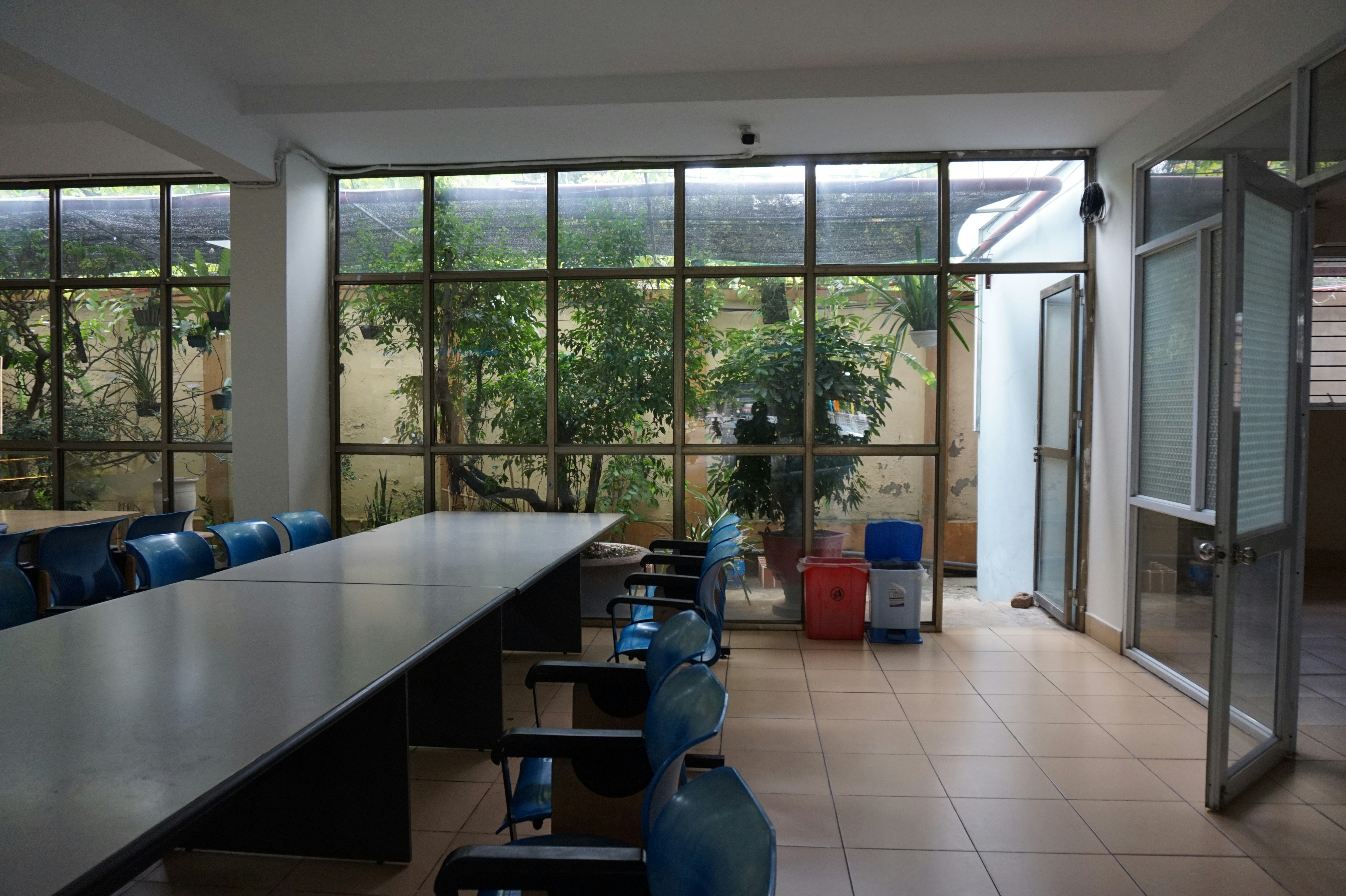 A room with a long table and several chairs