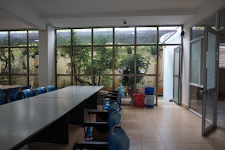 A room with a long table and several chairs