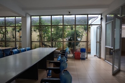 A room with a long table and several chairs