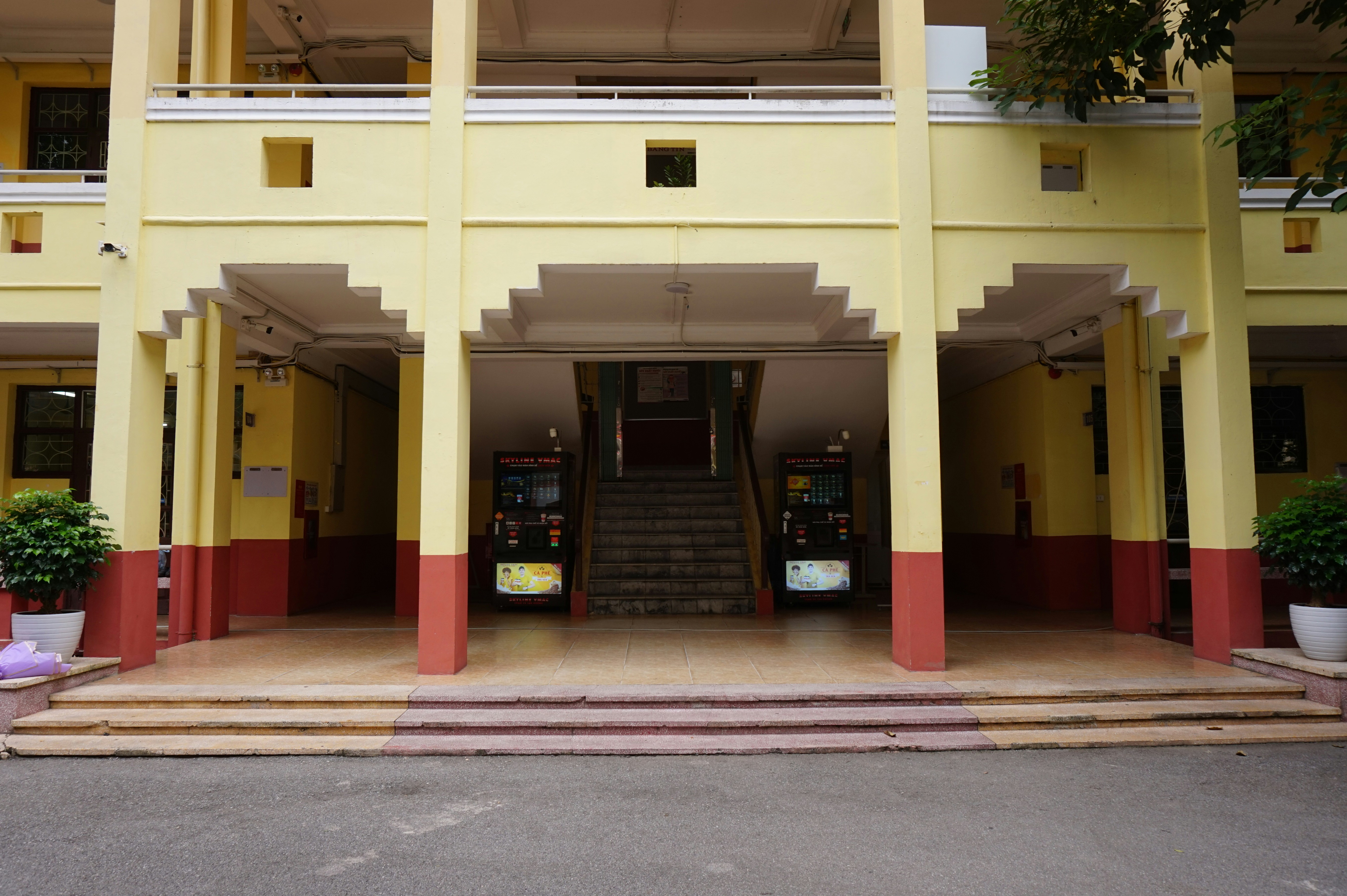 A large yellow building with a staircase leading up to it