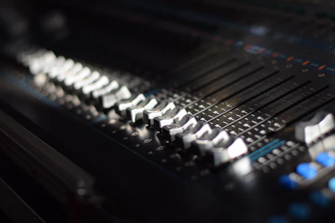 A close up of a sound mixing console