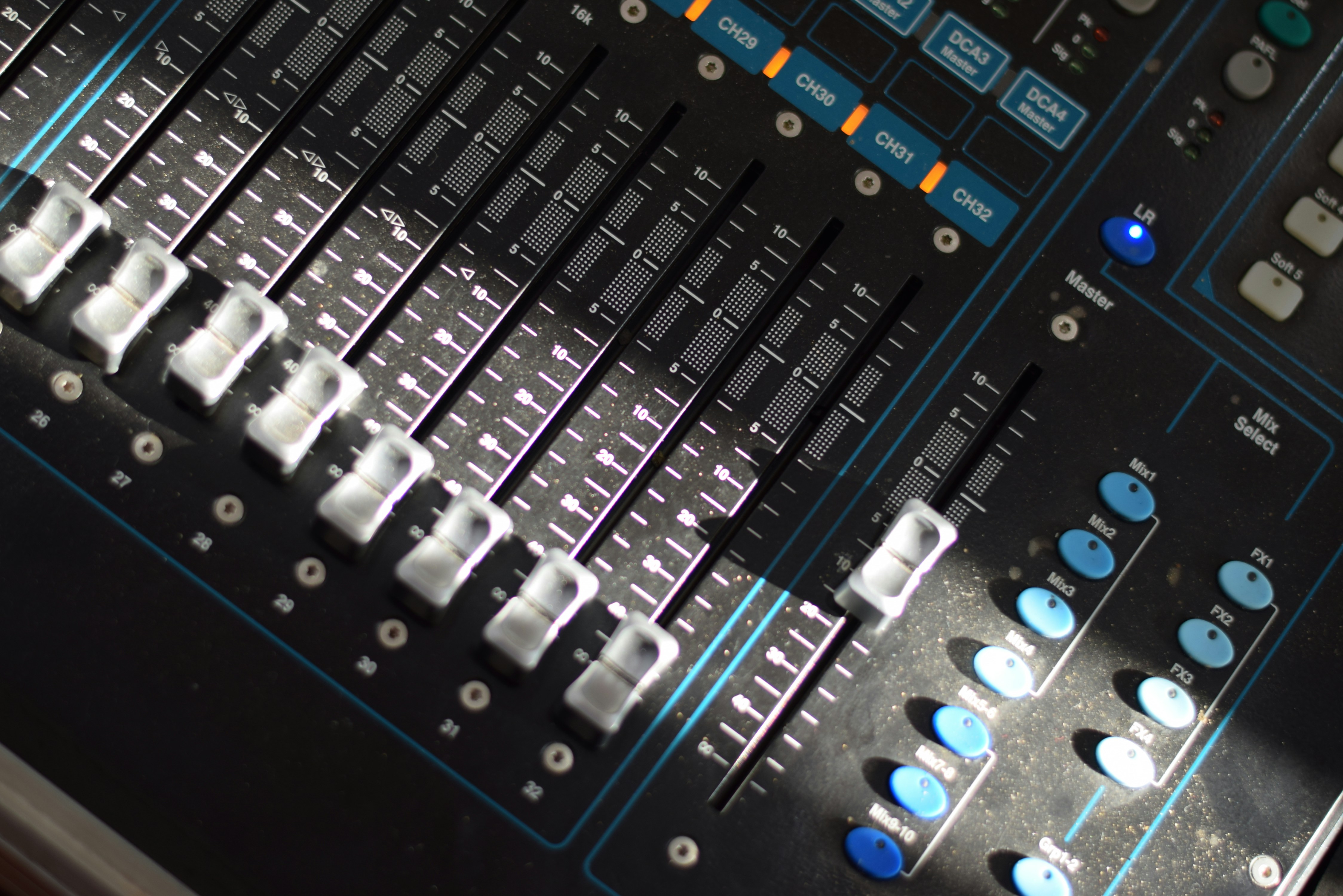A close up of a sound mixing console