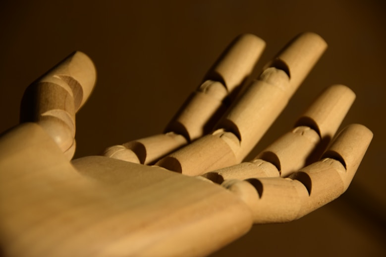A close up of a wooden toy hand