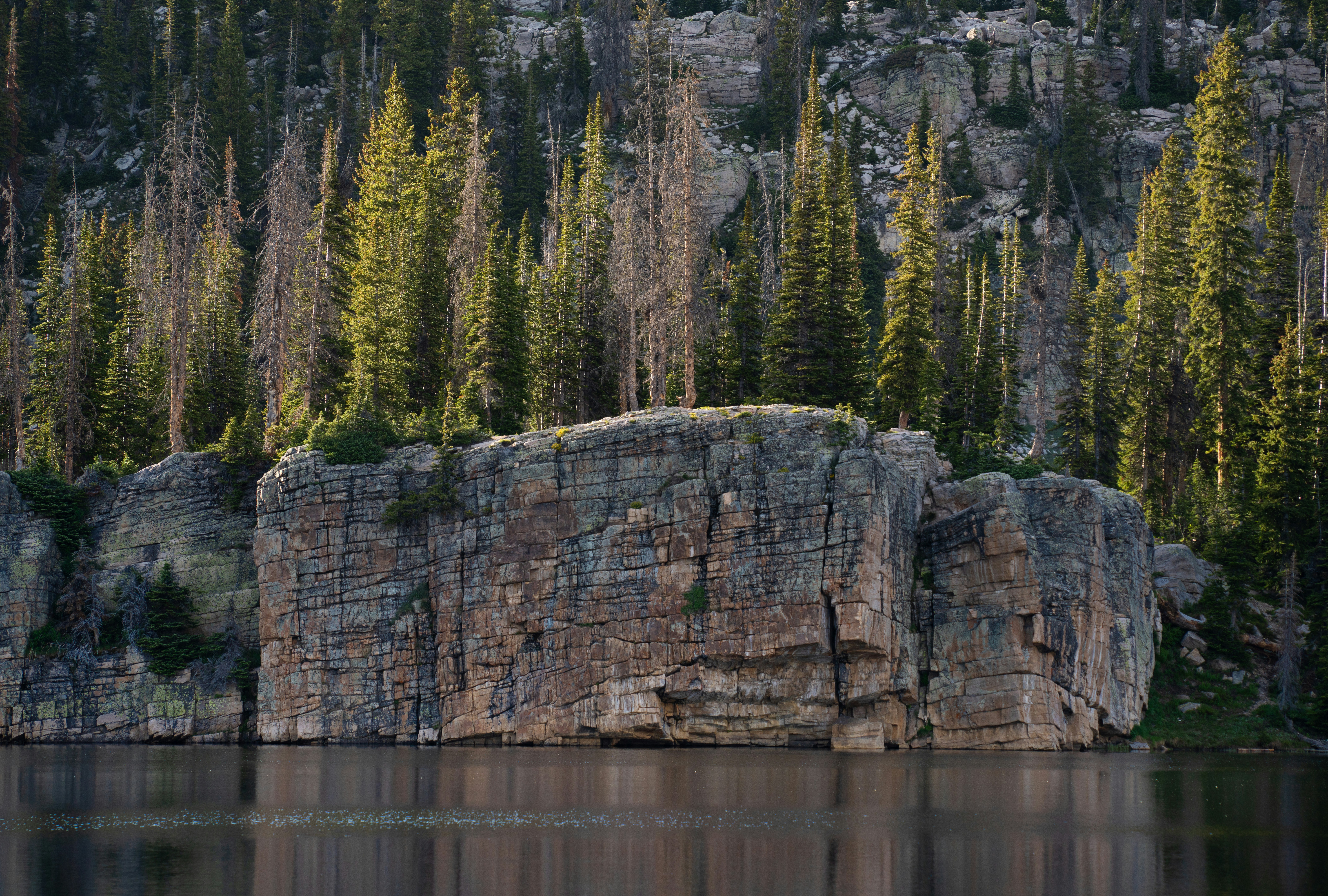 A large rock sitting in the middle of a lake