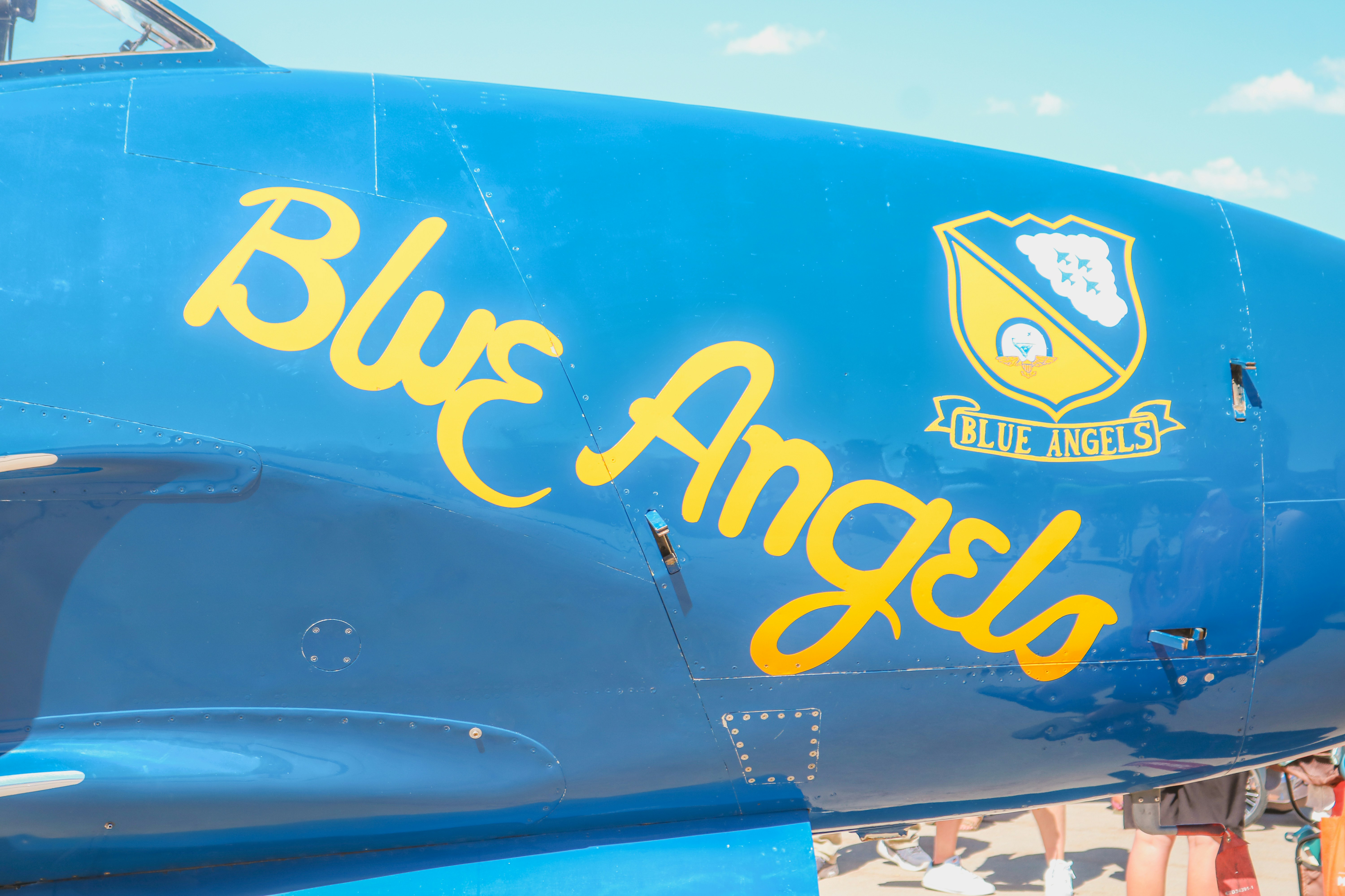 A close up of the side of a blue angel airplane