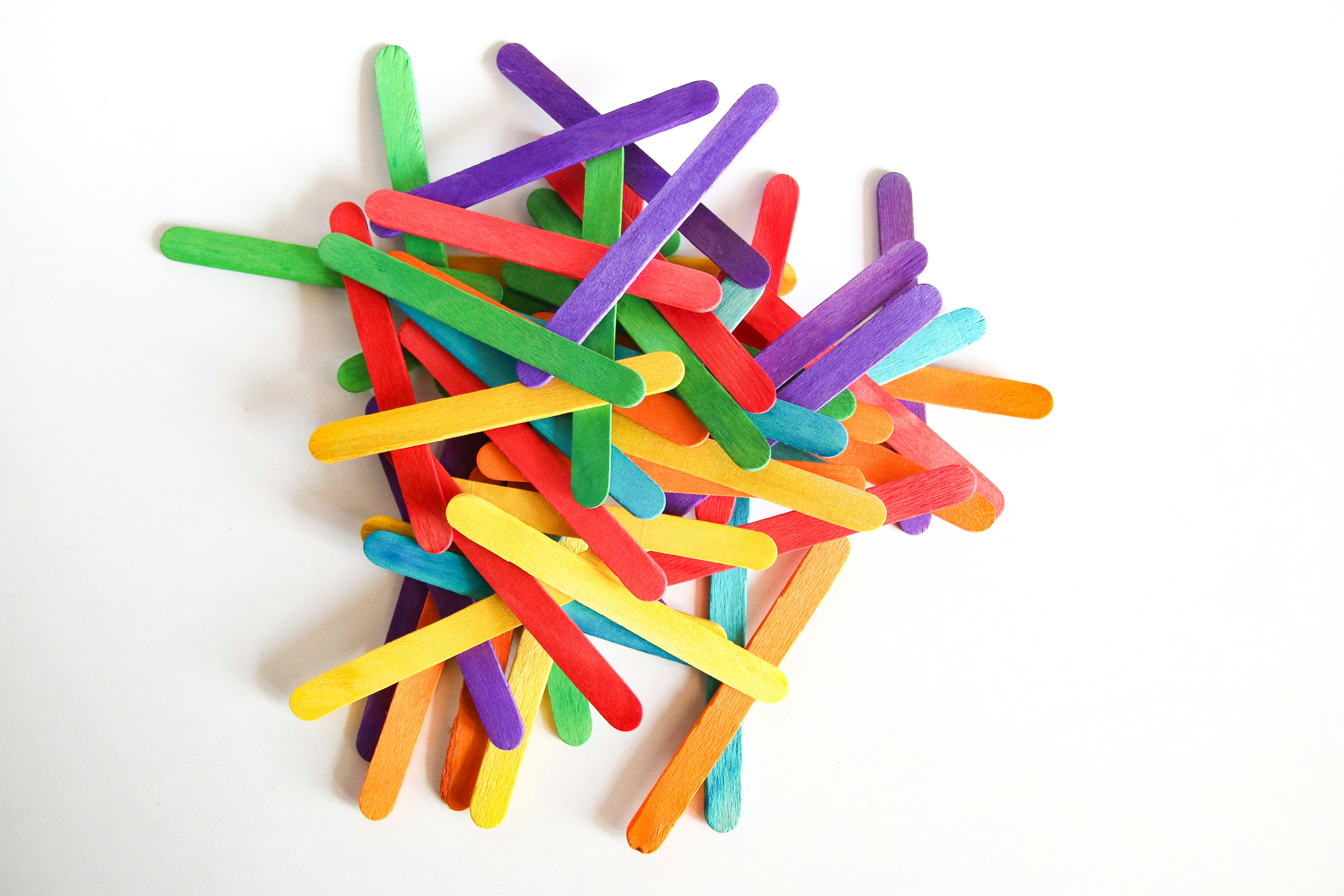 A pile of colored toothbrushes on a white background