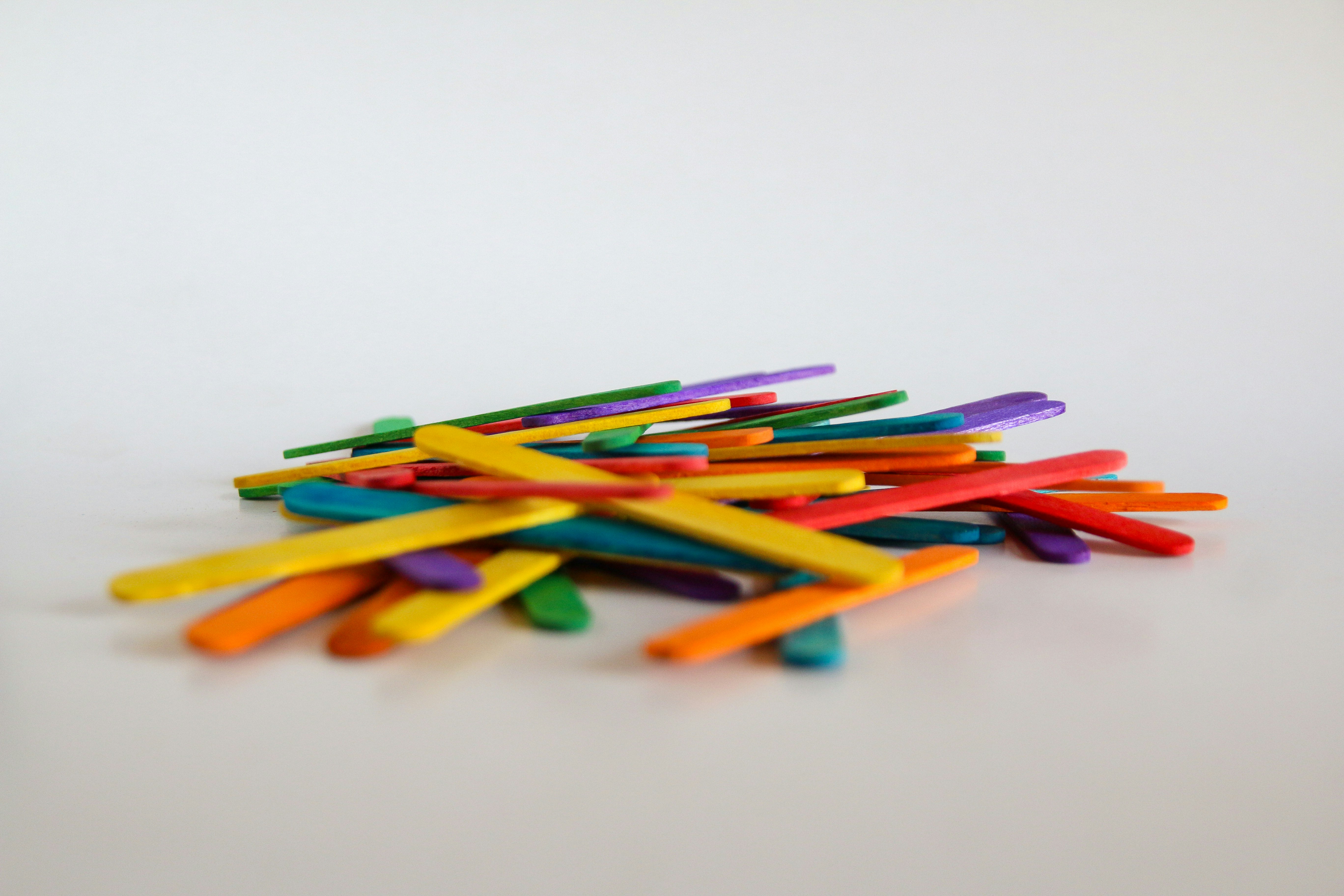 A pile of colored pencils sitting on top of a table