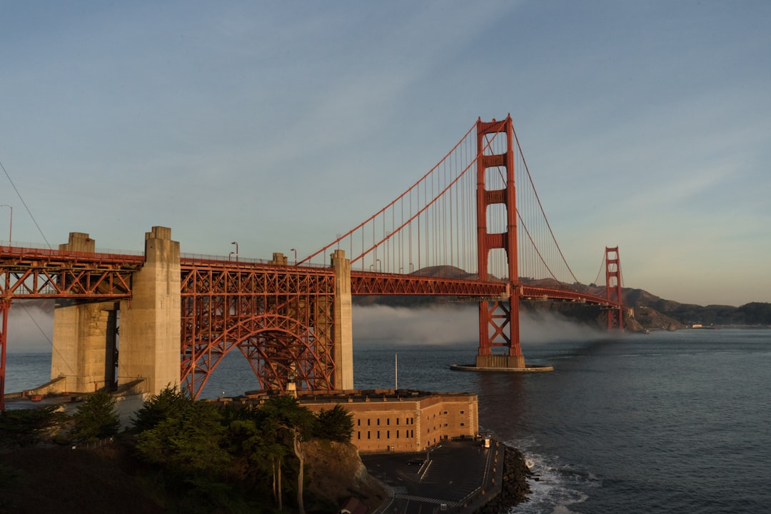 The golden gate bridge towering over the ocean,
