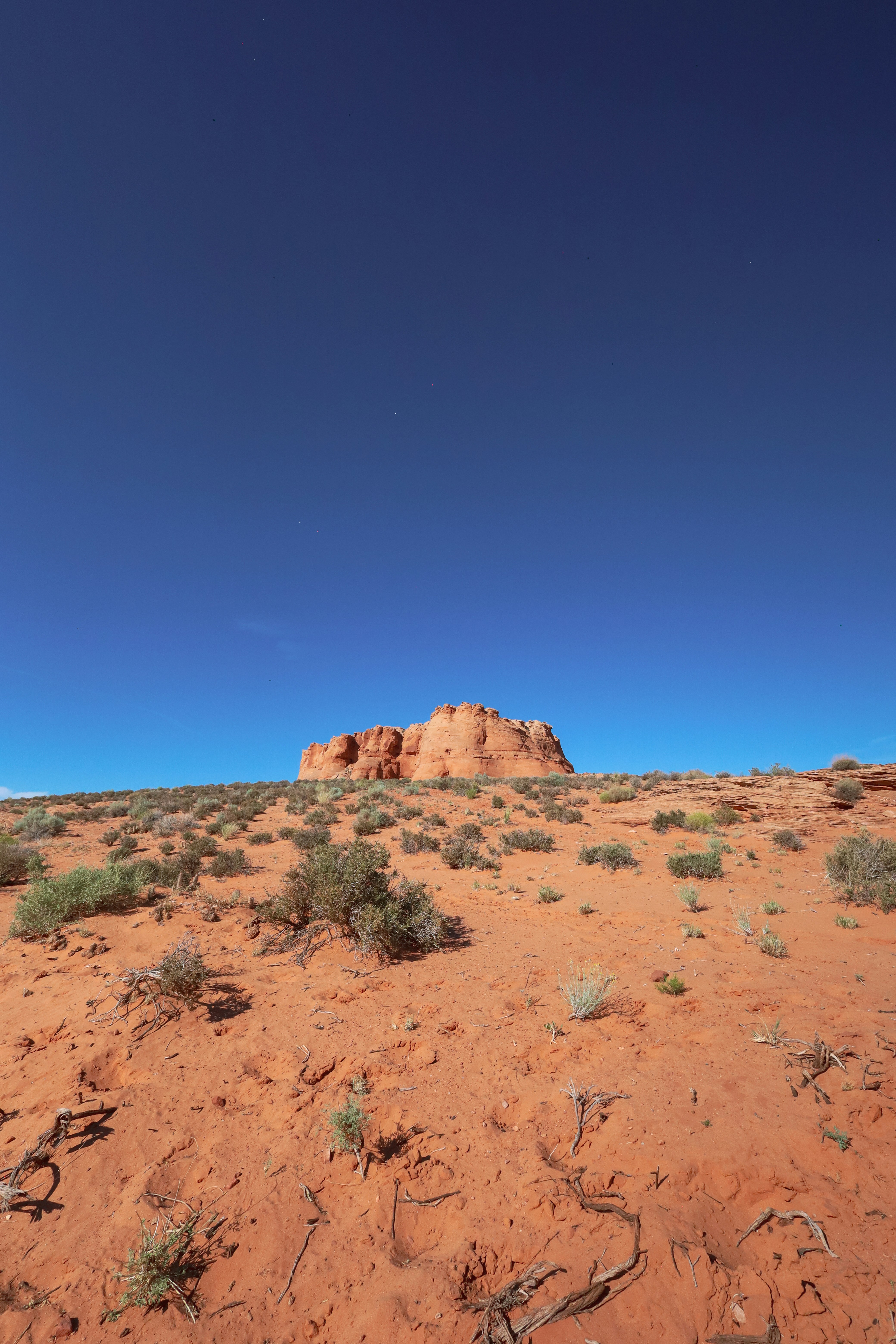 A desert landscape with a blue sky in the background