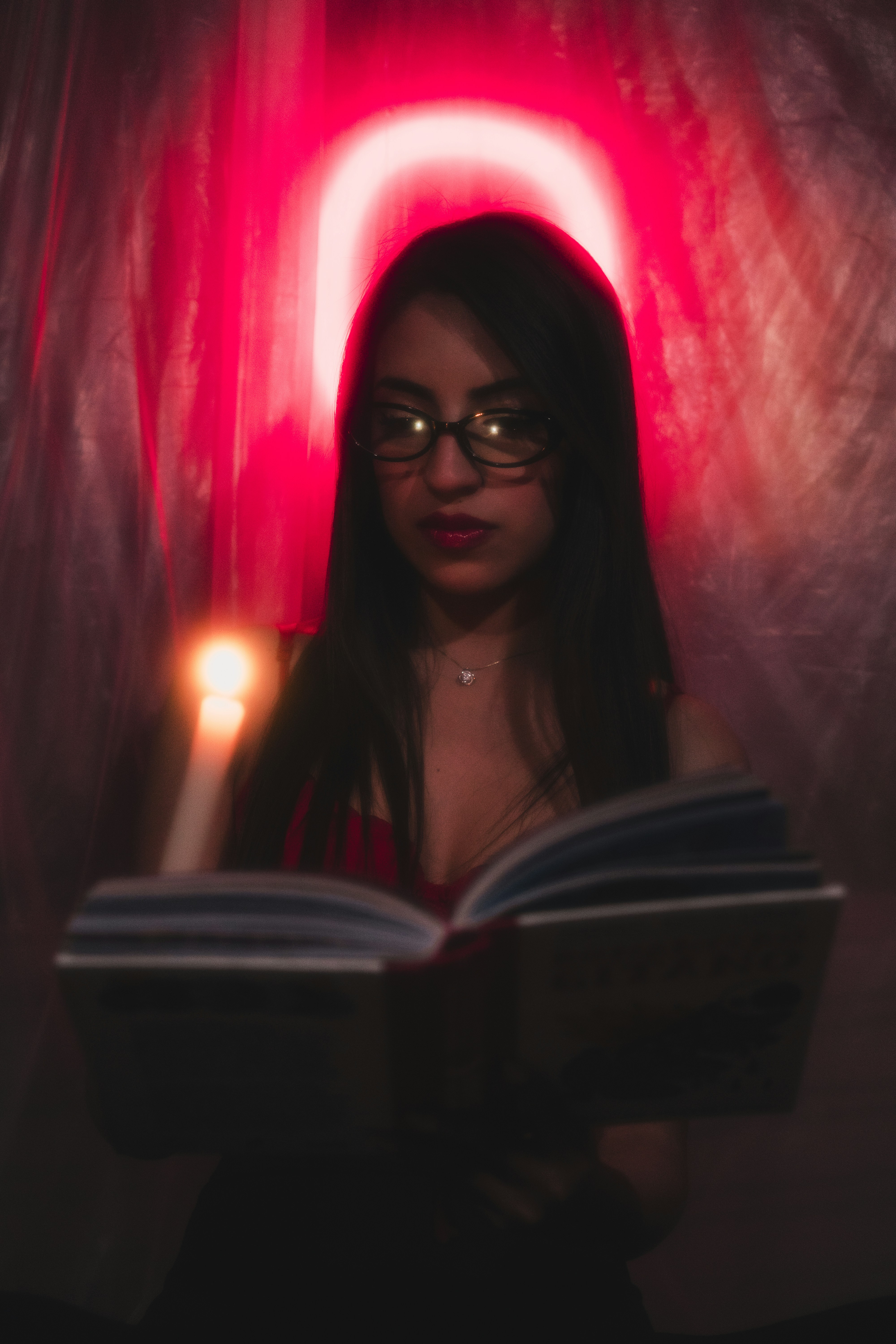 A woman reading a book in a dark room